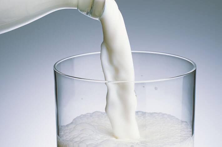 Photo of pouring milk into a glass