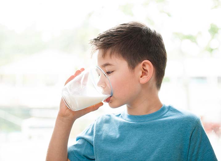 photo of a boy drinking milk