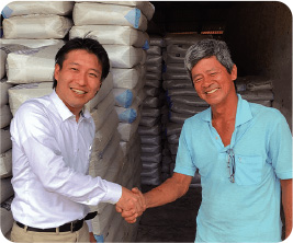 Cocoa farmer (right) and fertilizers distributed