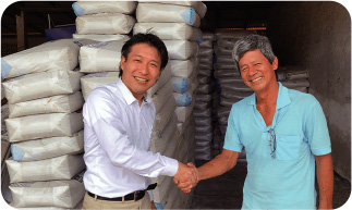 Cocoa farmer (right) and fertilizers distributed