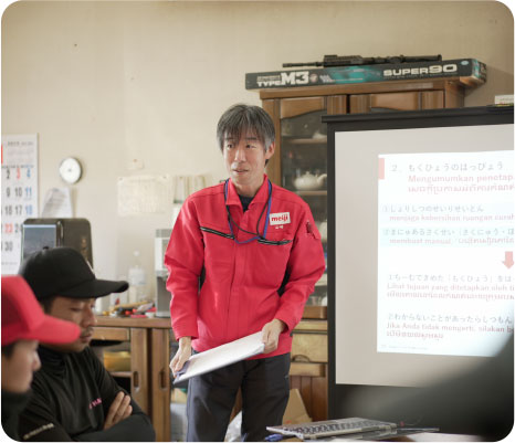 MDA representative explains to foreign staff with multilingual material.