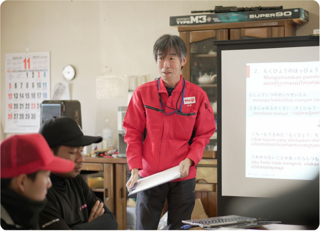 MDA representative explains to foreign staff with multilingual material.