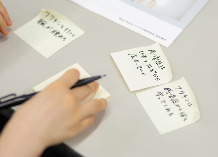 photo of a participant writing down their thoughts on sticky notes during the workshop
