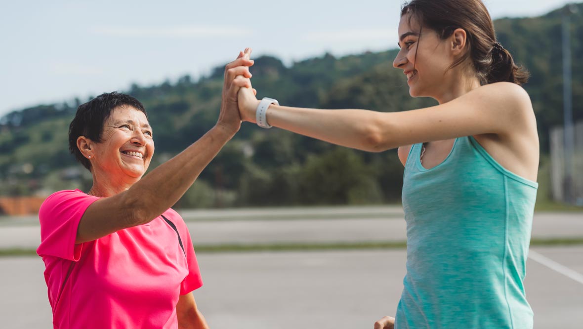 photo of women giving high five